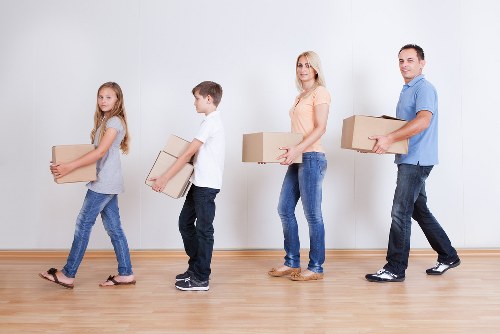 Professional movers handling furniture in an Ilford flat relocation